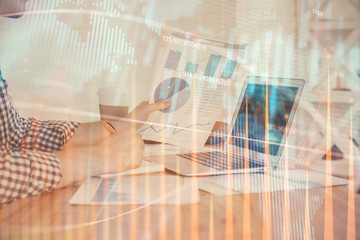 Double exposure of financial graph with man works in office on background. Concept of analysis.