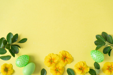 Creative layout made with colorful  flowers and Easter eggs. Minimal nature background. Spring...