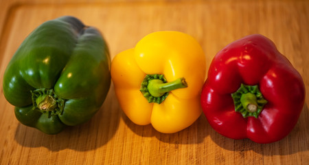 green, yellow and red organic ripe juicy bell peppers, close-up,