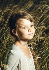 portrait of a beautiful girl in the field close-up