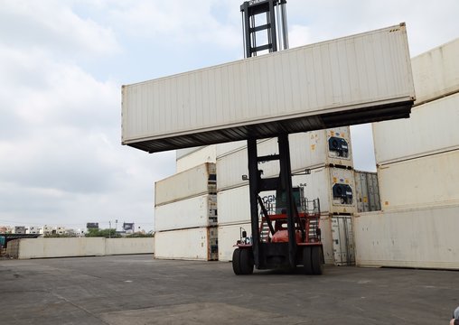 Toplifter handling cargo container loading to container trailer in import export logistic zone