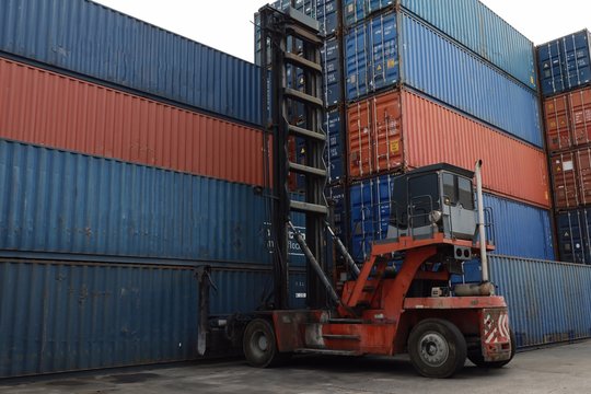 Toplifter handling cargo container loading to container trailer in import export logistic zone