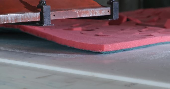 Paralon sponge factory, press conveyor, cutting red synthetic material into hexagonal dishwashing sponges, production process in factory, China, Chinese production, work continues despite quarantine