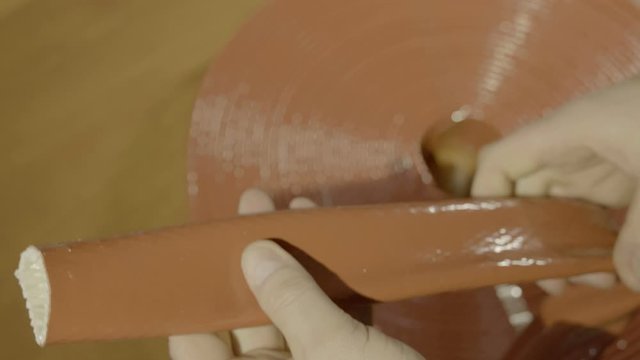 Men's hands hold a skewed non-flammable fabric