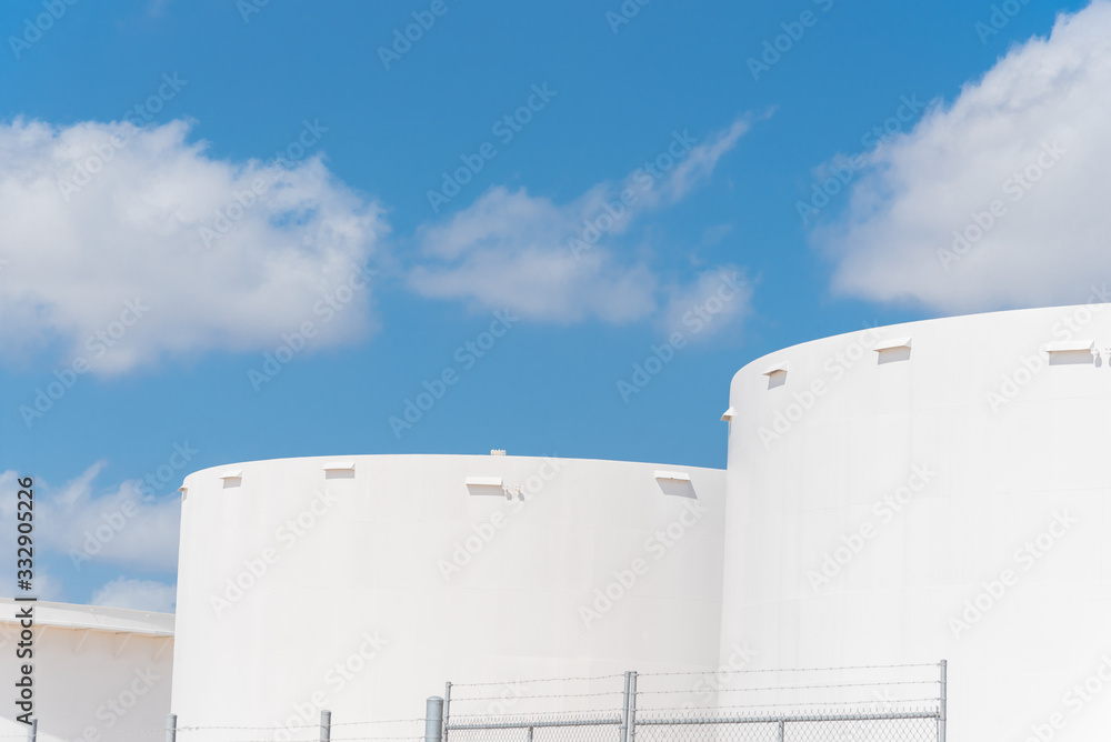 Wall mural close-up white oil storage tank in cloud blue sky in corpus christi, texas, america