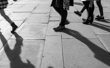 Shadow of People walking in crowded street. Black and White photo of shadow of people. Pedestrian in a street. Blur Shadows of people walking in a street of the city.