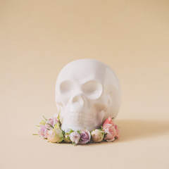 White skull with pink and purple spring flowers. Minimal love concept. Creative season idea.