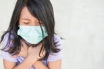 asia women wearing hygienic mask to prevent the virus PM2.5, Coronavirus, (2019-nCoV) asian little girl feeling unwell and coughing as symptom for cold or pneumonia,bronchitis. healthcare concept.