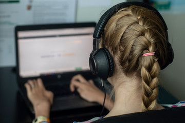 Coronavirus concept. Teenage girl sitting with her laptop - online learning from home
