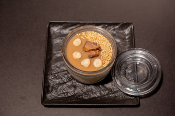 Japanese sweet in a transparent bowl on a black plate and on a black background