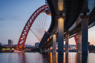 Obraz premium Sunset view of Picturesque bridge with big red arch over the Moscow river, Moscow, Russian Federation.