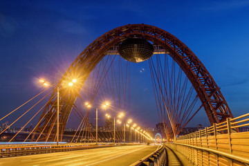 Obraz premium Sunset view of Picturesque bridge with big red arch over the Moscow river, Moscow, Russian Federation.