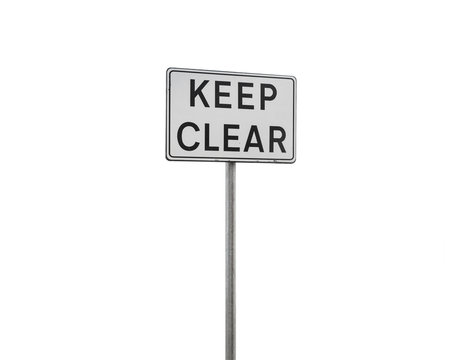 eep clear. Caution sign on a metal pole isolated