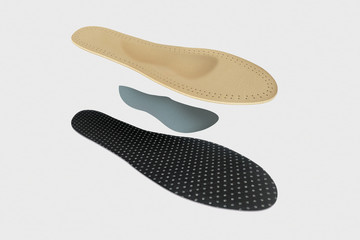 Isolated orthopedic insole on a white background. Treatment and prevention of flat feet and foot diseases. Foot care, comfort for the feet. Wear comfortable shoes. Medical insoles.