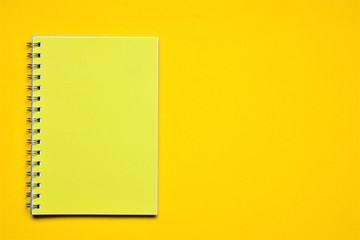 On yellow background, a notebook, space for text