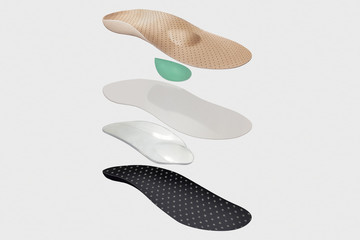 Isolated orthopedic insole on a white background. Treatment and prevention of flat feet and foot diseases. Foot care, comfort for the feet. Wear comfortable shoes. Medical insoles.