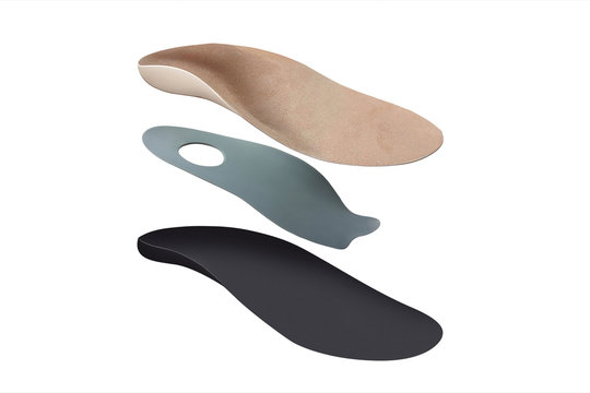 Isolated orthopedic insole on a white background. Treatment and prevention of flat feet and foot diseases. Foot care, comfort for the feet. Wear comfortable shoes. Medical insoles.