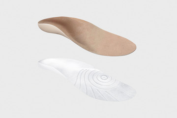 Isolated orthopedic insole on a white background. Treatment and prevention of flat feet and foot diseases. Foot care, comfort for the feet. Wear comfortable shoes. Medical insoles.