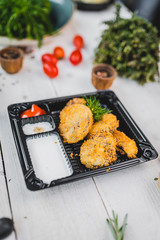 nuggets in in a container with sauces. fast food. view from above.