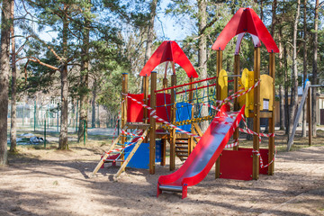Fototapeta na wymiar Closed, roped off children's playground amid COVID-19 Coronavirus pandemic in Europe