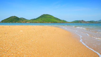 Peaceful sand beach with mountain and clear blue sky horizontal seascape., Thailand.