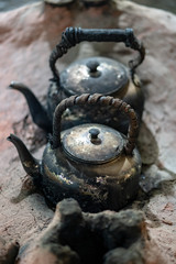old kettle with smoke in camping outdoor