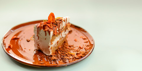 One piece of vanilla sponge cake biscuit with candied fruit and frosting served with mint on a white plate