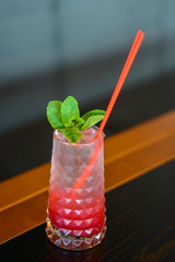 Red colorful refreshing cocktail with ice and lime. Fruit tropical mix drink.