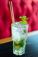 Green Mohito colorful refreshing cocktail with ice and lime. Fruit tropical mix drink.
