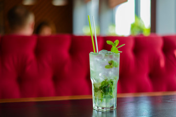 Green Mohito colorful refreshing cocktail with ice and lime. Fruit tropical mix drink.