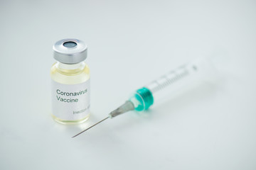 Close-up of syringe and coronovirus vaccine on gray background Pandemic Covid-19