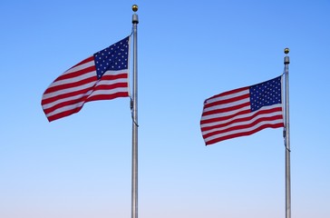 American flag of the United States of America  floating in the sky on a mast
