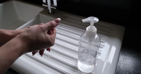 Woman using hand sanitizer to prevent corona virus spread