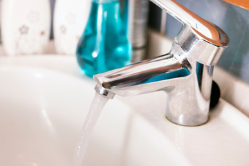 running water faucet in the bathroom
