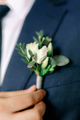 groom holding a bouquet of flowers