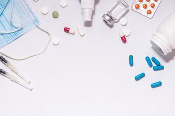 Creative flat lay overhead composition with medical supplements on white background with copy space for your text. Pandemic prevention concept.