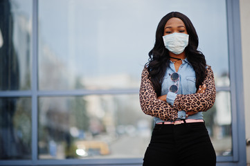 African american young volunteer woman wearing face mask outdoors. Coronavirus quarantine and...