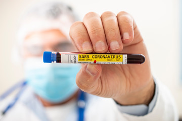 Fototapeta premium Doctor holding test tube blood sample