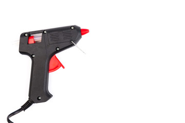 Electric hot glue gun on white background. Rods for glue gun