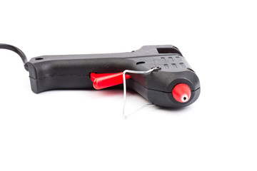 Electric hot glue gun on white background. Rods for glue gun