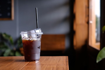 Ice Coffee Americano Plastic  On Wood Background  Cafe 