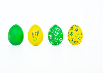 The concept of celebrating Easter. Colored and flower pattern painted eggs on white background. Copy space. Isolated. Close up