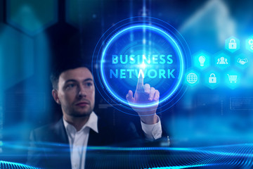 Business, Technology, Internet and network concept. Young businessman working on a virtual screen of the future and sees the inscription: Business network