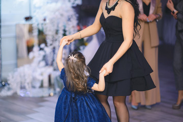 mother and daughter dancing together