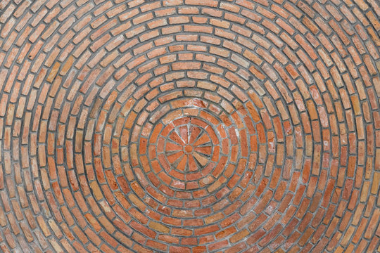Beautiful bottom up view to the brick ceiling and antique chandelier. Texture of red brickwork. Rough surface. For background and design.