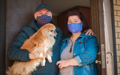 Family man and woman in mask with pet on street because of air pollution and epidemic in city....