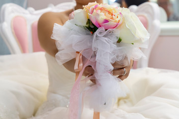 Fototapeta premium The bride holds a beautiful wedding bouquet of pink and white flowers in her hands