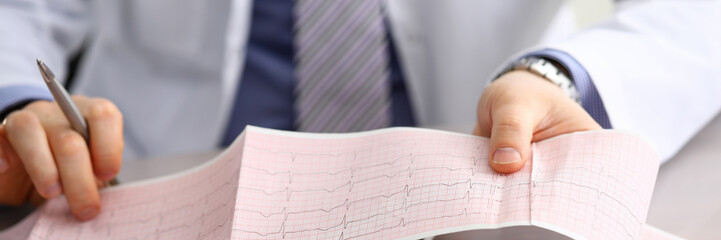 Doctor explains cardiogram data, consultation.