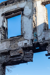 Ruined old house. And the blue sky. The remains of old houses. Abandoned city. The city of ghosts. The ruins of old historic buildings destroyed by an earthquake.