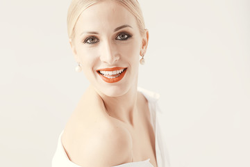 Fototapeta premium model with professional make-up and bright red lips / beautiful make-up on the face of the model, saturated with bright red lipstick on the lips